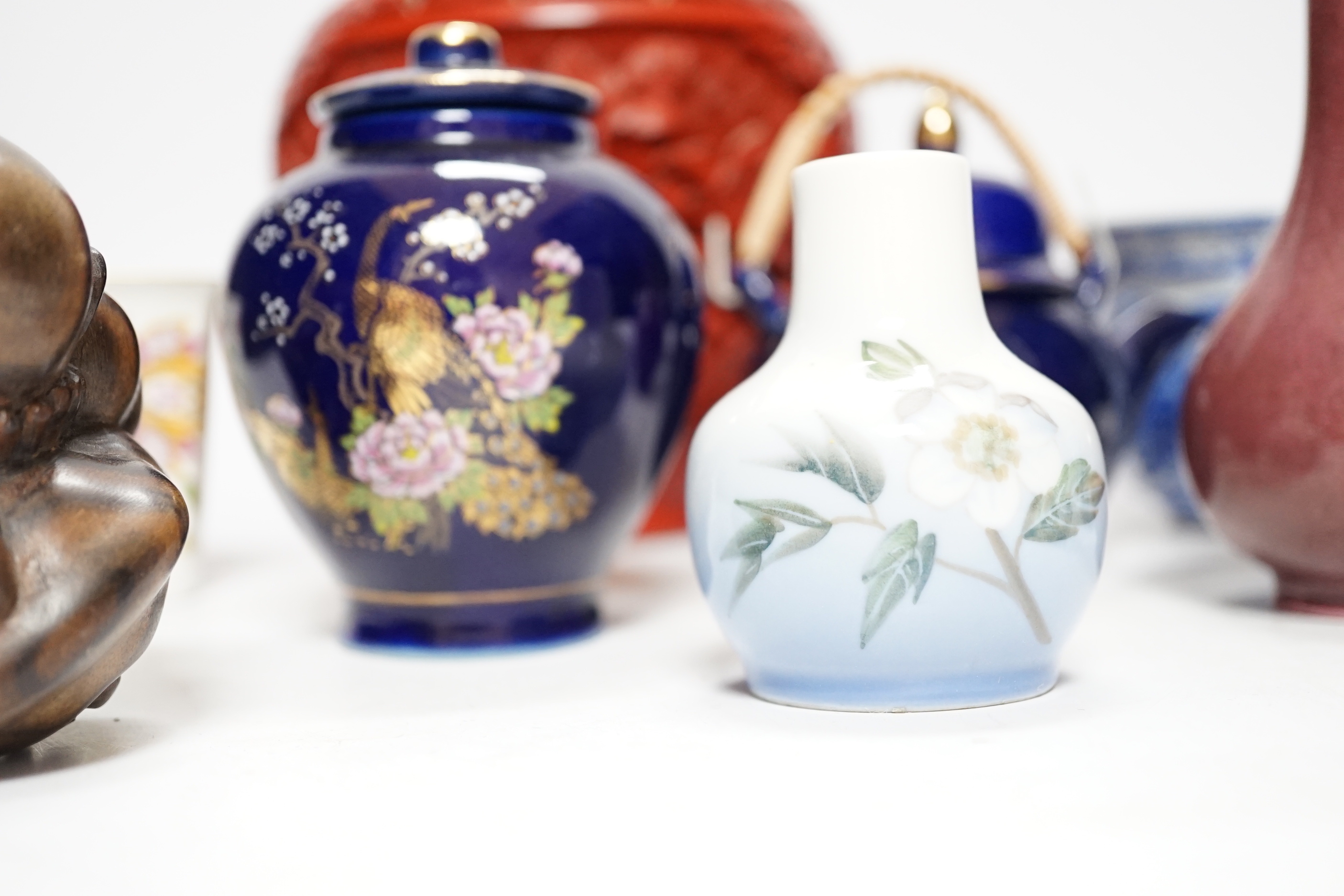 A Chinese cinnabar lacquer jar and cover, a Chinese copper red bottle vase, a carved wood figure, a Meissen miniature bowl and other ceramics, jar 15cm